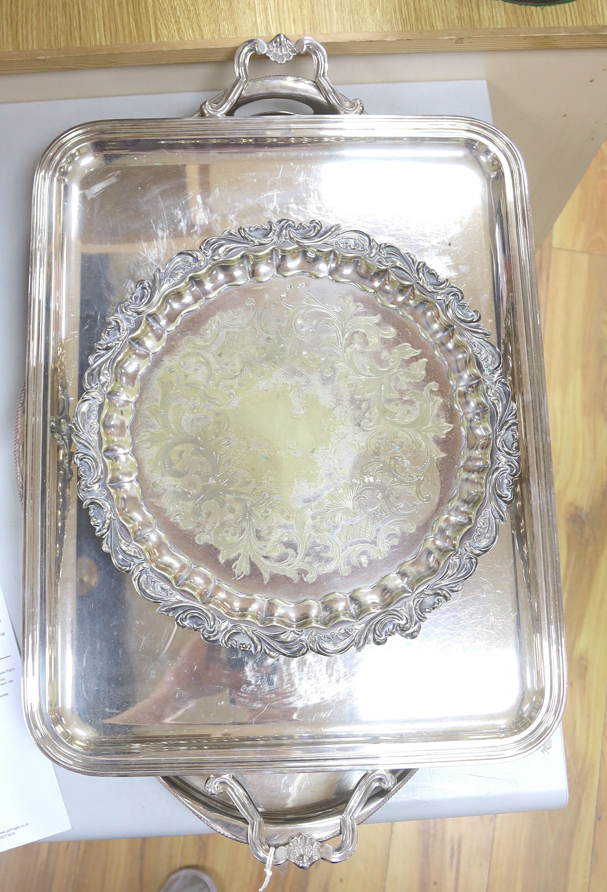 A plated oval tray, a rectangular tray, overall width 67cm, and a plated salver